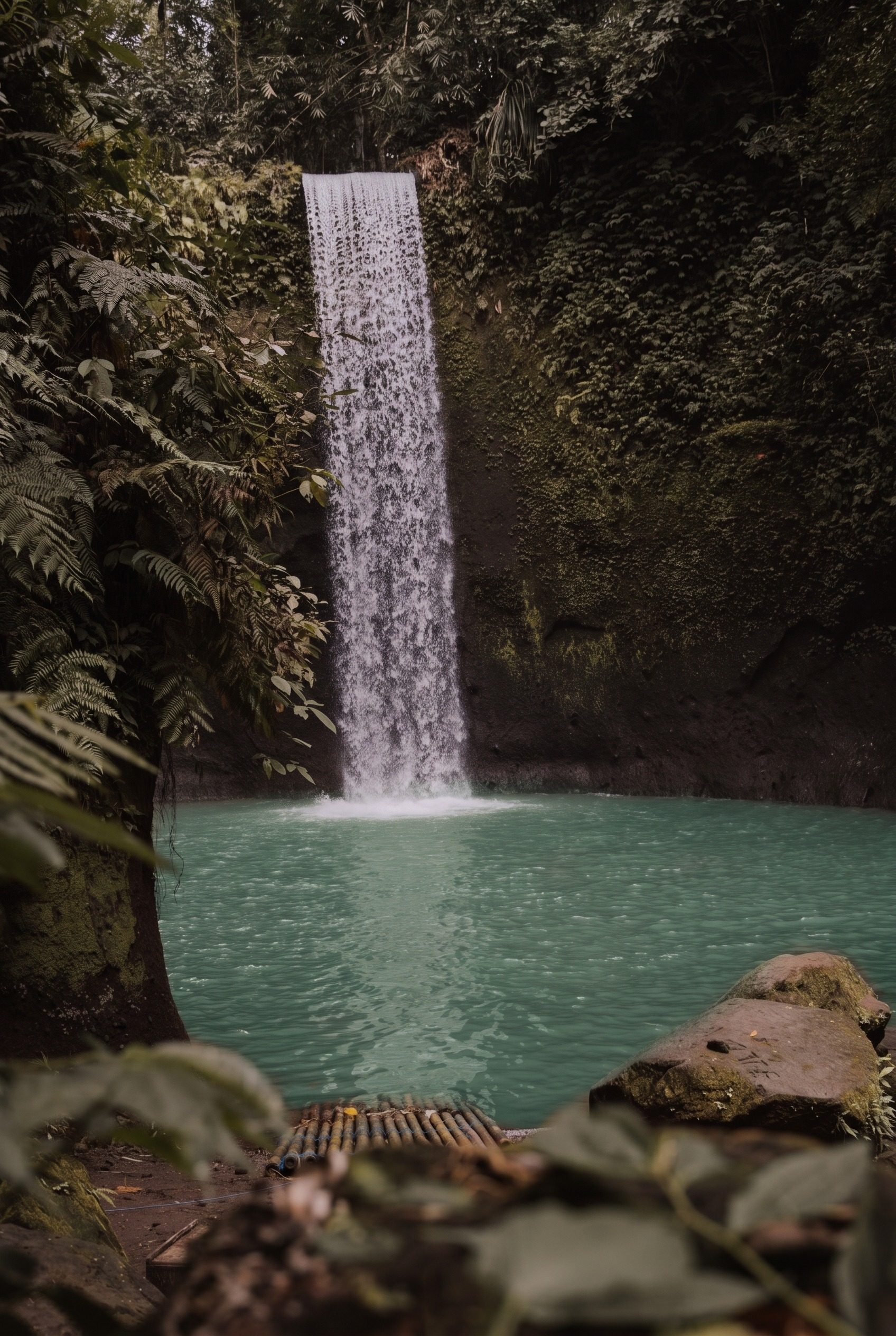 A hidden waterfall and its turquoise pool in the hills