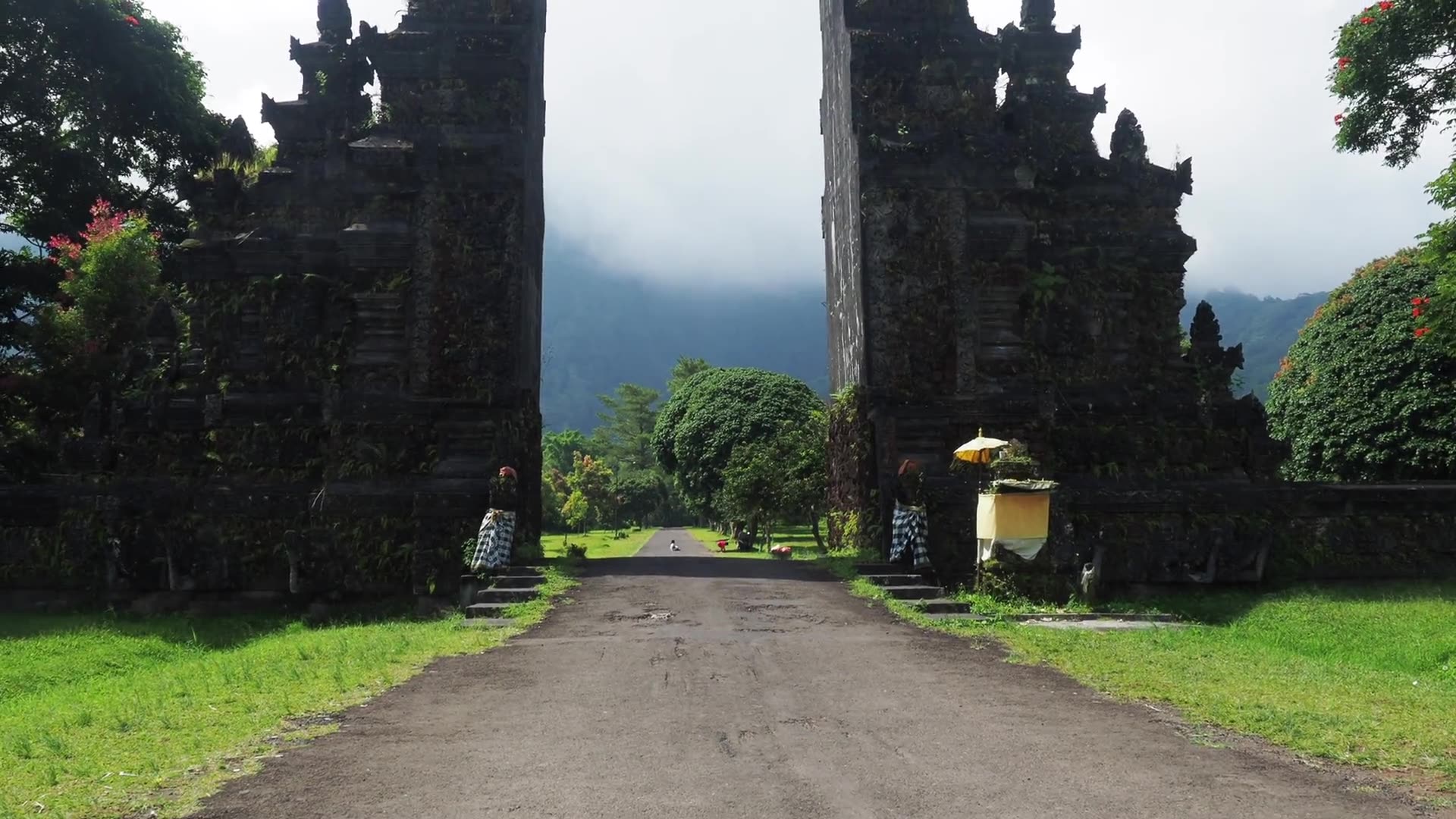 An empty road approaching an ancient Balinese gate
