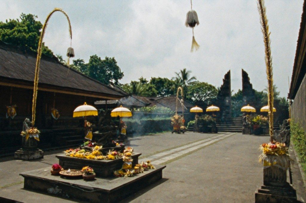 A Balinese temple anniversary, offerings and tall bamboo poles