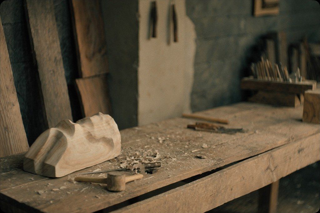 A woodcarver's chisels and a half formed carving in Mas