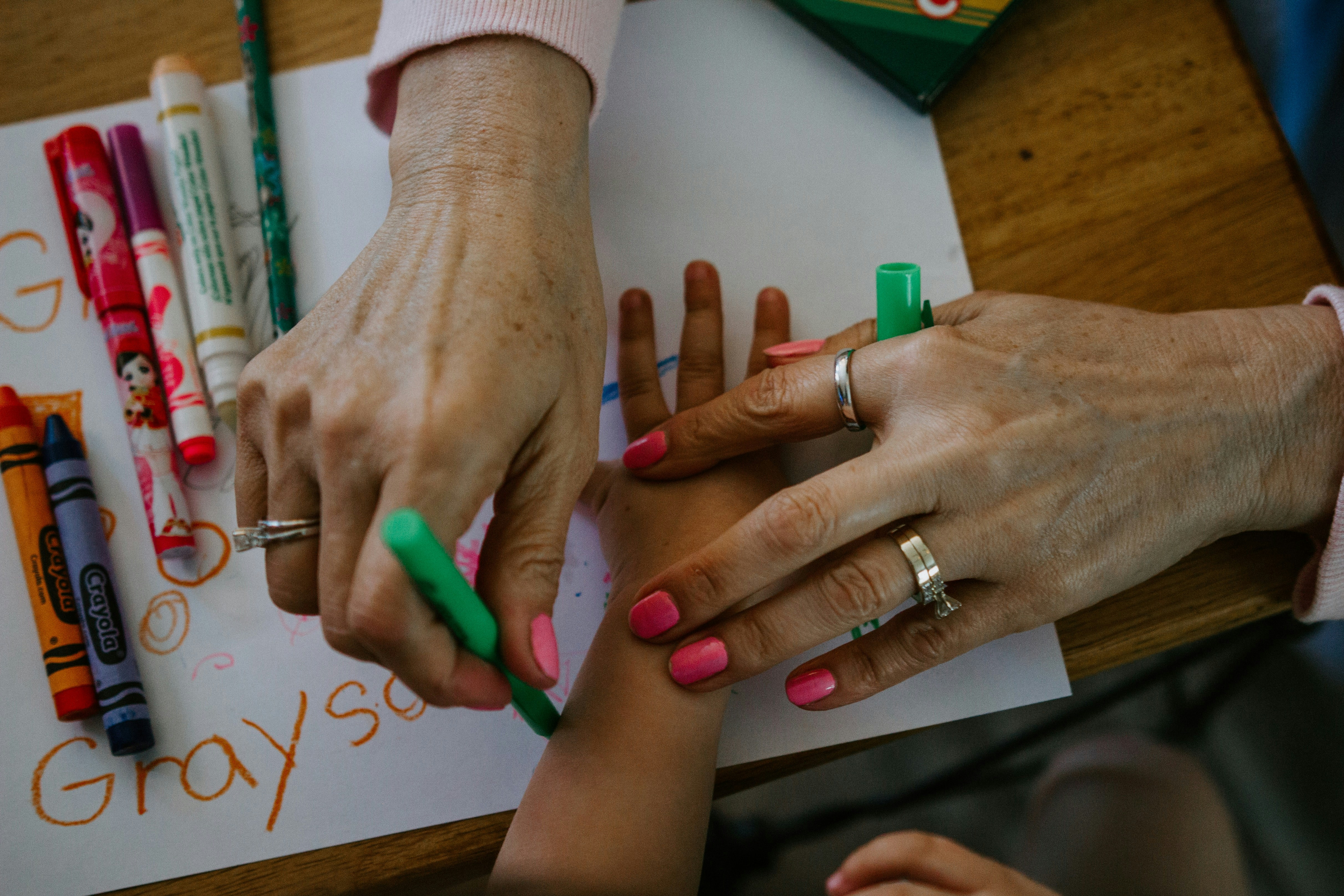 A nanny and child quietly making something at the villa kitchen